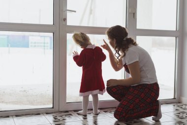 Child girl with cochlear implant plays at home. Hear impairment and diversity and hearing aid