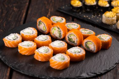 Rolls set with fish and shrimp caviar sushi with chopsticks - asian food and japanese cuisine concept
