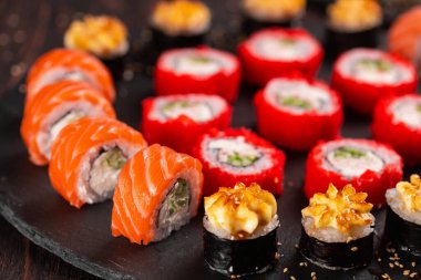 Rolls set with fish and shrimp caviar sushi with chopsticks - asian food and japanese cuisine concept