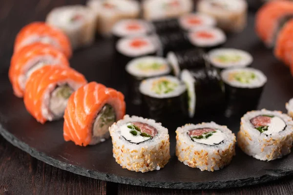 Rolls set with fish and shrimp caviar sushi with chopsticks - asian food and japanese cuisine concept