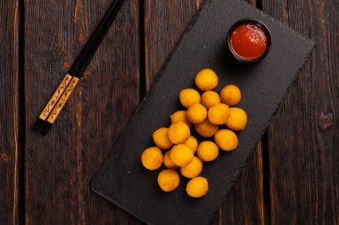 fish balls in batter with chopsticks - asian food