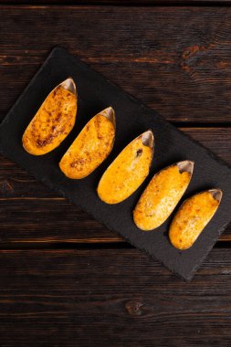 Fresh mussel baked with cheese top view - french or japanese cuisine.