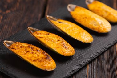 Baked mussels with cheese sesame and seeds in shells - asian food