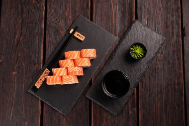 Roll wish fish sushi with chopsticks