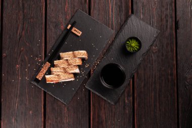 Sushi roll with smoked eel and salmon with cucumber and cheese. Traditional delicious fresh sushi roll set. Sushi menu. Japanese cuisine restaurant. Asian food.