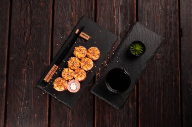 Sushi roll philadelphia with salmon and cucumber and cream cheese on black background. Sushi menu. Japanese food