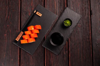 Roll wish fish sushi with chopsticks