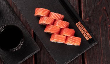 Roll wish fish sushi with chopsticks