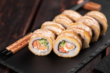 Roll wish fish sushi with chopsticks