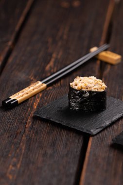 Set of Gunkan Maki Sushi with different types of fish salmon, scallop, perch, eel, shrimp and caviar on wooden table background. Sushi menu. Japanese food sushi set gunkan