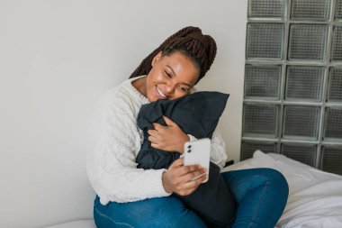 African american woman making video call, in kitchen - social networks