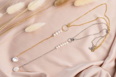 Handmade jewelry on a textile background. Gift for women. Bijouterie and jewellery for a women