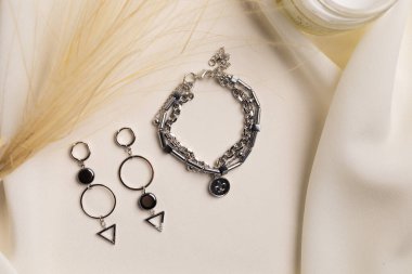 Handmade jewelry on a textile background. Gift for women. Bijouterie and jewellery for a women