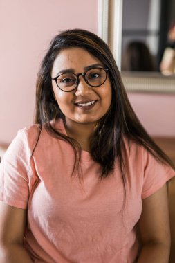 Head shot portrait smart confident smiling millennial indian woman. Attractive young hindu teenager student girl freelancer looking at camera, posing for photo