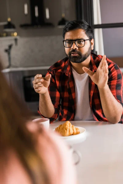 Young Diverse Loving Couple Eating Croissant Talks Together Home Breakfast — Stockfoto