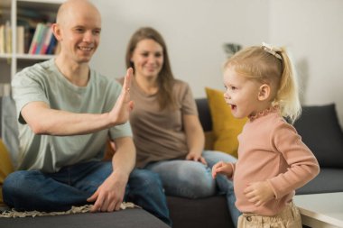 Deaf child girl with cochlear implant studying to hear sounds - recovery after cochlear Implant surgery and rehabilitation
