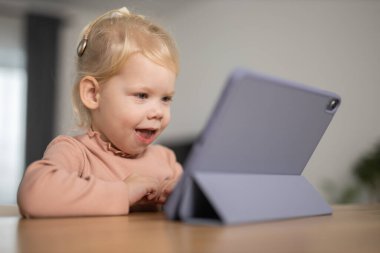Deaf child girl with cochlear implant studying to hear sounds - recovery after cochlear Implant surgery and rehabilitation