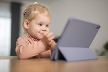 Deaf child girl with cochlear implant studying to hear sounds - recovery after cochlear Implant surgery and rehabilitation