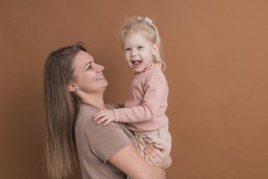 Deaf child girl with cochlear implant studying to hear sounds - recovery after cochlear Implant surgery and rehabilitation