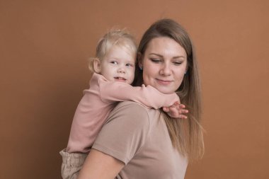 Deaf child girl with cochlear implant studying to hear sounds - recovery after cochlear Implant surgery and rehabilitation