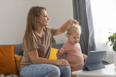 Deaf child girl with cochlear implant studying to hear sounds - recovery after cochlear Implant surgery and rehabilitation