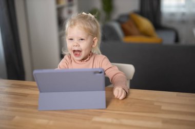 Deaf child girl with cochlear implant studying to hear sounds - recovery after cochlear Implant surgery and rehabilitation