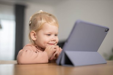 Deaf child girl with cochlear implant studying to hear sounds - recovery after cochlear Implant surgery and rehabilitation