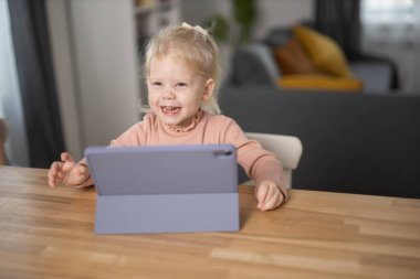 Deaf child girl with cochlear implant studying to hear sounds - recovery after cochlear Implant surgery and rehabilitation