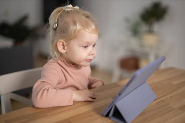 Deaf child girl with cochlear implant studying to hear sounds - recovery after cochlear Implant surgery and rehabilitation