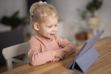 Deaf child girl with cochlear implant studying to hear sounds - recovery after cochlear Implant surgery and rehabilitation