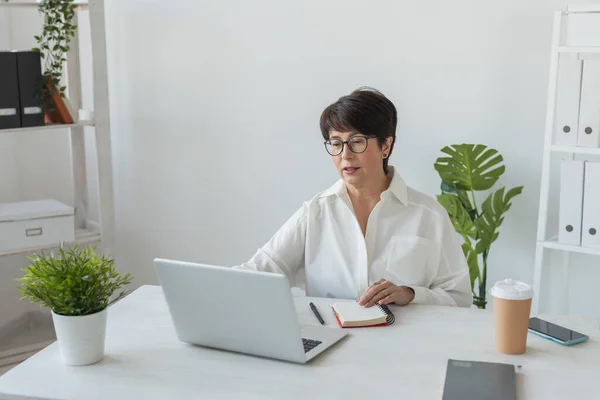 stock image Businesswoman working in office video call with laptop. Female professional making videocall