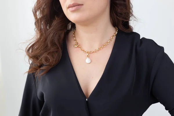 Close up attractive female model cross silver necklace. Woman wearing jewellery. Jewellery photo for e commerce and online sale social media concept