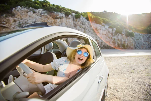 stock image Young woman drive and having fun in cabrio against mountains - travel and summer voyage nature