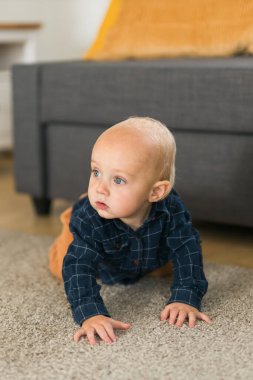 Nursery baby crawling on floor indoors at home - Baby curiosity and child development stages