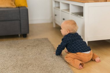 Nursery baby crawling on floor indoors at home - Baby curiosity and child development stages