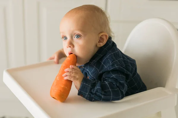 Little Boy Blue Shirt Sitting Childs Chair Eating Carrot Baby — Fotografia de Stock