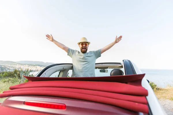 stock image Happy woman sitting in white convertible car with beautiful view