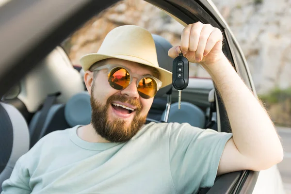 stock image Handsome happy man showing key of new car - Rental and buy new car