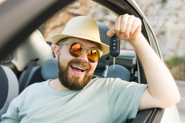 Stock image Handsome happy man showing key of new car - Rental and buy new car