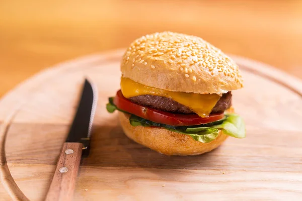 stock image Beef burgers on wooden desk. Fat unhealthy food closeup