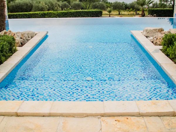 Home swimming pool in garden and villa terrace - summer holidays and luxury lifestyle
