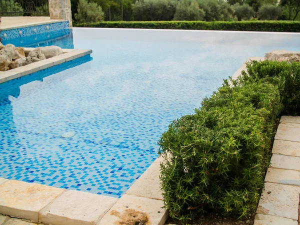 Home swimming pool in garden and villa terrace - summer holidays and luxury lifestyle