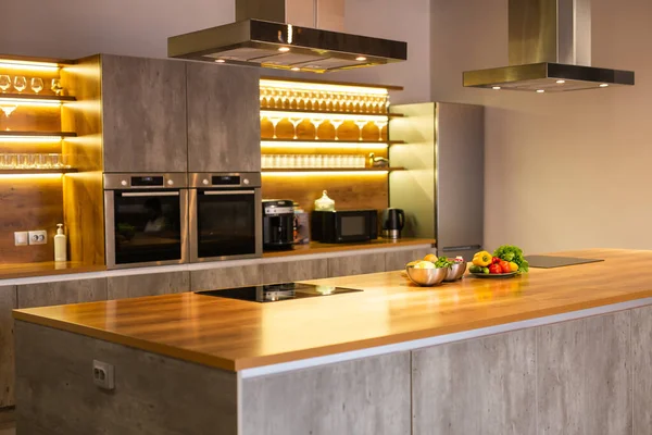 新しい高級住宅やキャビネットやステンレス製の家電でモダンなミニマリストスタイルのキッチン — ストック写真