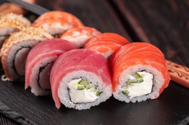 Rolls set with fish salmon and shrimp and tuna maguro eel sushi with chopsticks - asian food and japanese cuisine