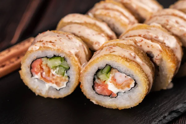 Roll wish fish sushi with chopsticks