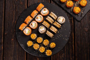 Rolls set with fish and shrimp caviar sushi with chopsticks - asian food and japanese cuisine concept