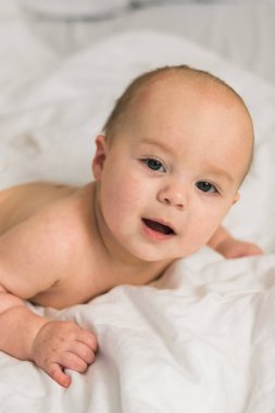 Mutlu bebek yatakta yatıp gülüyor. Alfa ve alfa jenerasyonu..