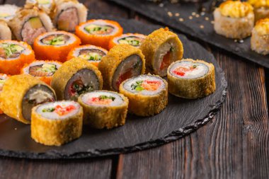 Rolls set with fish and shrimp caviar sushi with chopsticks - asian food and japanese cuisine concept