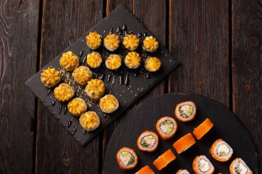 Rolls set with fish and shrimp caviar sushi with chopsticks - asian food and japanese cuisine concept