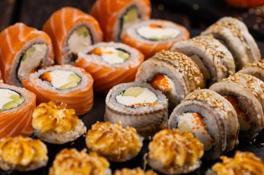 Rolls set with fish and shrimp caviar sushi with chopsticks - asian food and japanese cuisine concept